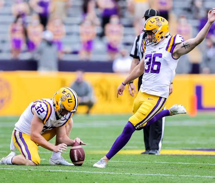 Apr 17, 2021; Baton Rouge, Louisiana, USA; LSU Tigers place kicker Cade York (36) kicks a field goal with place kicker Avery Atkins (32) holding the ball during the first half of the annual Purple and White spring game at Tiger Stadium. Mandatory Credit: Stephen Lew-USA TODAY Sports